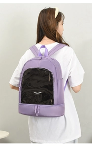 Detail view of purple nylon backpack featuring clear PVC front pocket and bottom zip layer