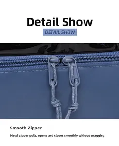 Detail view of smooth double metal zippers with woven pull cords on a navy nylon backpack