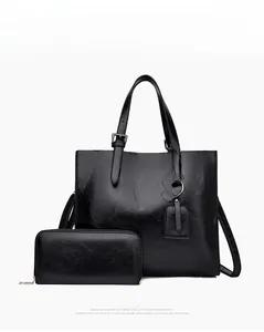 Front view of black tote bag set with embossed ROMSA lettering and matching wallet