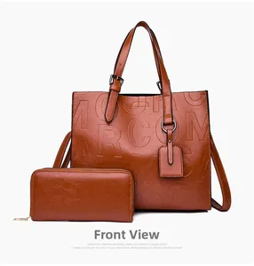 Macro shot of tan embossed leather tote and matching zipper wallet set