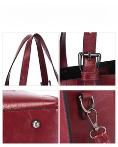 Detail view of red leather tote featuring adjustable strap and bottom metal rivets