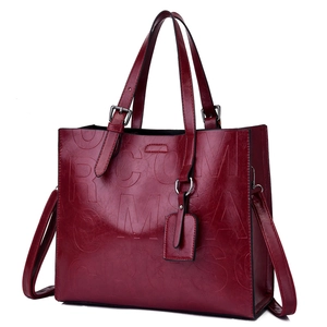 Deep red large capacity tote bag with embossed letter design and top handles