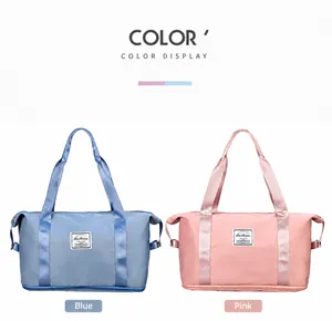 Detail view of large nylon duffel bags in pink and blue colors with Fashion labels