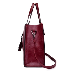 Elegant burgundy embossed leather shoulder bag with spacious interior and adjustable strap