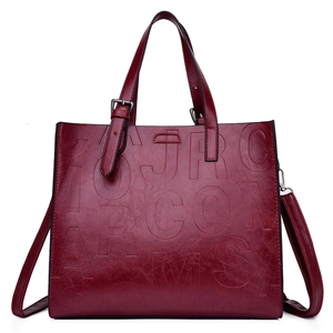 Deep red embossed leather tote bag with sturdy top handles and detachable shoulder strap