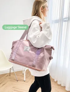 Pink large sports travel bag with a practical luggage trolley sleeve and dual handles