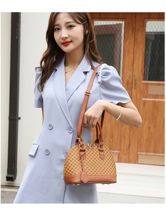 Brown shell bag with vintage pattern shown on a model against a rustic background