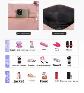 Detail of pink waterproof travel bag featuring internal compartments and back zipper pocket