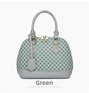 Detailed view of green shell bag featuring geometric print and pale gold hardware accents