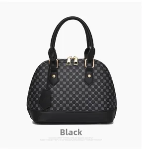 Detailed close-up of shell-shaped handbag with classic geometric monogram pattern