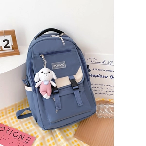 Minimalist blue nylon backpack with large capacity and cute white rabbit plush charm