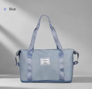 Blue travel bag detail showing the bottom shoe compartment and waterproof fabric texture