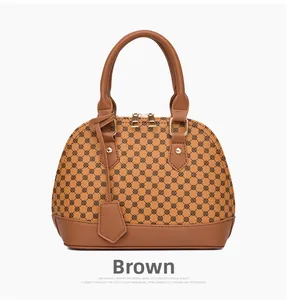Detail of yellow shell-shaped handbag with circular patterns and golden zipper closure