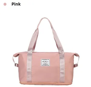 Close-up of pink travel duffel bag showing fashion tag and double top handles