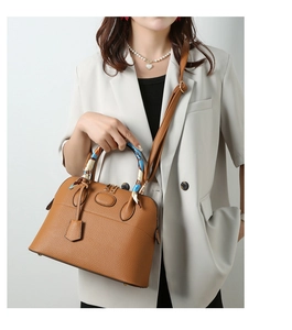 Brown litchi leather handbag with decorative blue scarf handle and shoulder strap detail