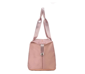 Detail of light pink travel bag showing the spacious dual compartment and bottom shoe storage