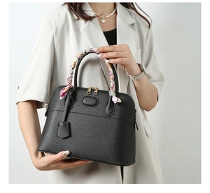 Detail of black lychee grain tote bag with printed silk scarf wrapped around handle