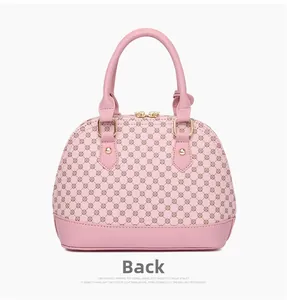 Detail view of the back of a pink shell bag featuring a vintage geometric floral pattern