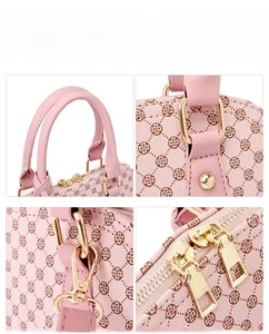 Macro detail of pink shell bag featuring clover pattern leather and gold metal hardware