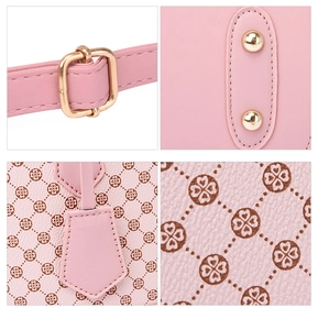 Detail of pink shell bag with four-leaf clover print and gold-tone metal hardware