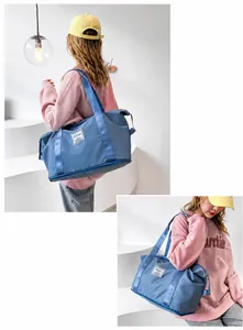 Detail of light blue waterproof nylon gym bag with wide shoulder strap and large capacity
