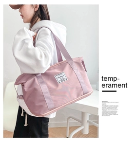 Detail of pink waterproof nylon travel bag with wide purple shoulder strap and Fashion label