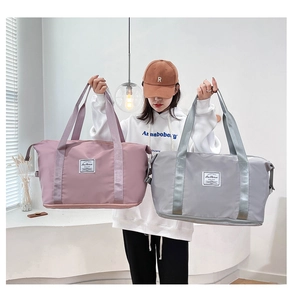 Detail of pink and grey waterproof nylon travel bags with bottom expansion layer