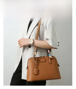Brown litchi leather tote bag with decorative silk scarf on handle and shoulder strap