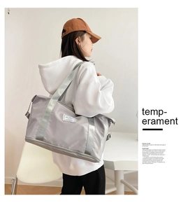 Detail of grey travel bag with widened shoulder strap and wet-dry separation pocket