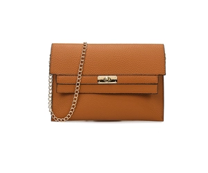 Detail of tan pebble leather crossbody bag with a gold twist lock and chain strap
