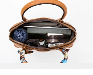 Top view of large brown leather tote bag interior showing spacious multi-pocket design
