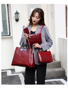 Detail of 4-piece dark red crocodile embossed tote bag set with snakeskin pattern accents