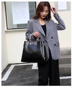 Chic black crocodile embossed tote bag paired with stylish snakeskin pattern handles