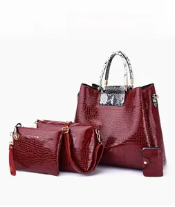 Detail of red 4-piece handbag set featuring crocodile pattern and snakeskin handles
