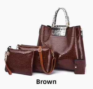 Detail of a 4-in-1 brown faux crocodile tote bag set with snakeskin pattern handles