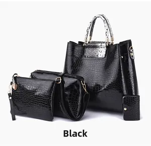 Detail of 4-piece black crocodile embossed handbag set with snake print handles