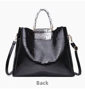 Rear view of black crocodile pattern tote bag featuring stylish snakeskin handles