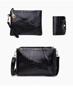 Detailed set of black crocodile embossed handbag, matching wallet, and wristlet pouch