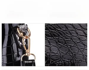 Macro detail of black crocodile embossed leather with snakeskin trim and gold metal hardware