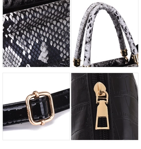 Detail of luxury snake print handles and gold-tone hardware on multi-piece tote bag