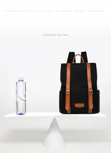 Lightweight black backpack weighing only 0.5kg compared with a water bottle