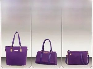 Detailed view of the multi-piece purple nylon tote bag set with premium golden hardware