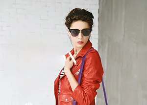 Detail of red biker jacket with metal zippers and wide lapel on a stylish fashion model