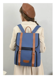 Back view of a woman wearing a blue and brown color-block backpack with nylon material