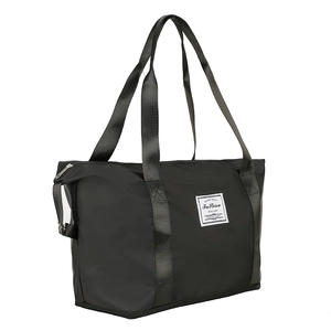 Large black waterproof nylon travel bag with shoulder straps on white background