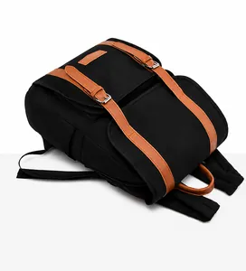 Top view of a black nylon backpack with brown leather straps and silver buckles