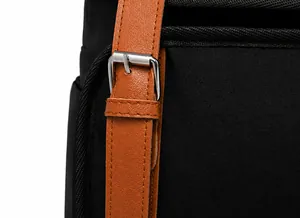 Detail of contrast color backpack with brown leather strap and silver metal buckle closure