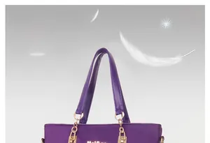 Detail of purple nylon tote bag featuring gold chain link and durable strap connector