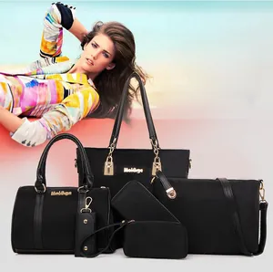 Detailed set of six black nylon bags including tote and crossbody with gold hardware