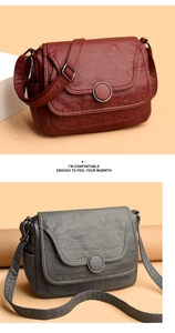 Detail of dark red and grey soft faux leather crossbody bags with metal buckle